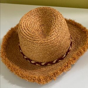 Ruggine Raffia Hat with fringed brim and red band. One size.